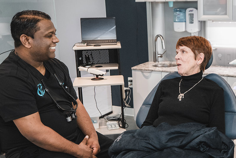 Dr. Jose speaking with dental implant patient