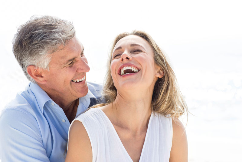 Dental implant patients smiling.